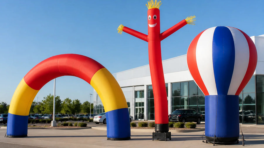 An inflatable arch, tube man, and cold-air advertising balloon set up outside a business storefront